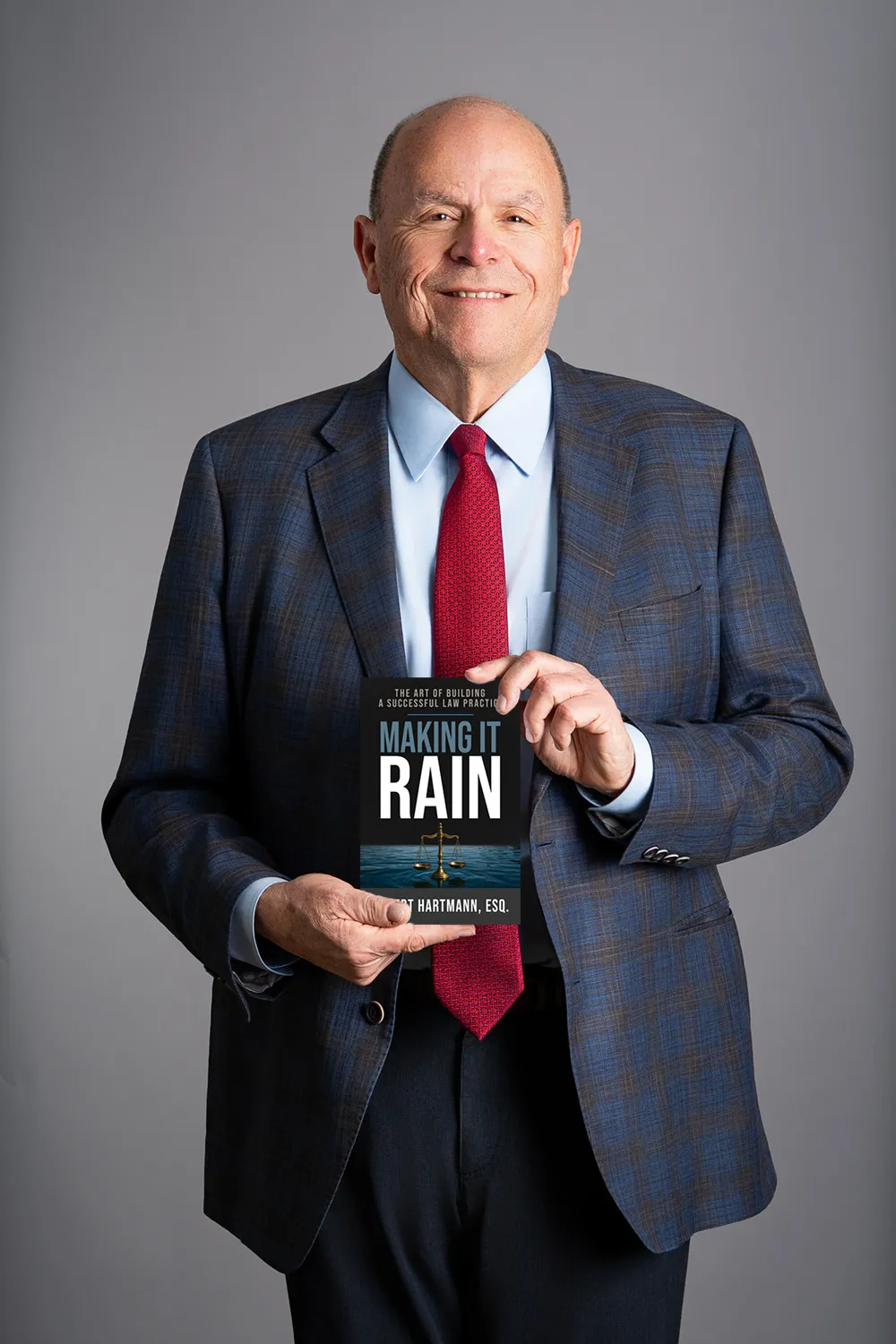 ROBERT HARTMAN holding his book: Making It Rain
